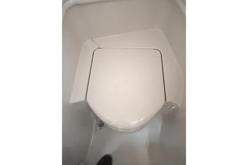 Slide: The Image of Boat bathroom with closed toilet seat on 2006 Sea Ray 320 Sundancer. - 62