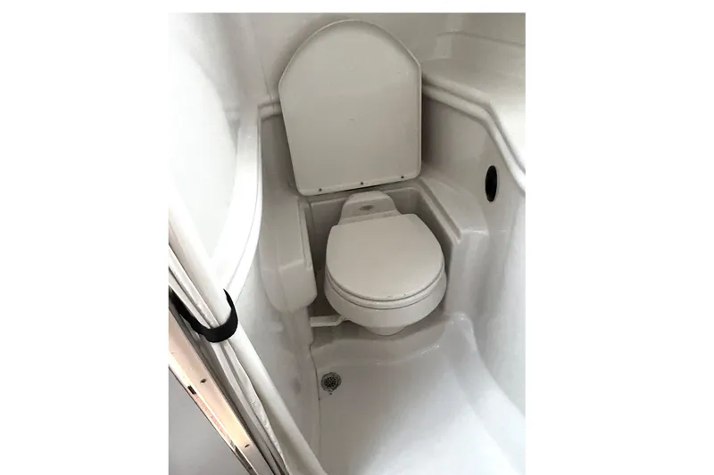 Slide: The Image of 2006 Sea Ray 320 Sundancer boat bathroom with compact toilet. - 63