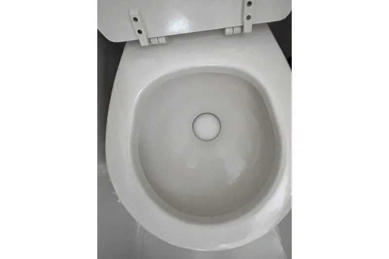 Slide: The Image of White toilet bowl on a 2006 Sea Ray 320 Sundancer boat. - 64