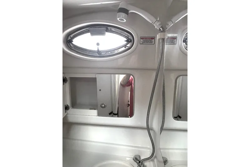 Slide: The Image of 2006 Sea Ray 320 Sundancer bathroom with showerhead and porthole window. - 65
