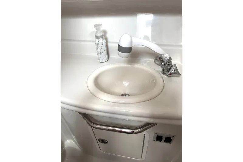 Slide: The Image of 2006 Sea Ray 320 Sundancer bathroom sink with faucet and soap dispenser. - 66