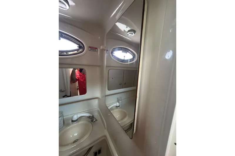 Slide: The Image of Bathroom interior of 2006 Sea Ray 320 Sundancer with sink and mirror. - 68