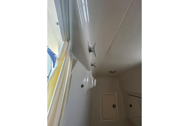 Slide: The Image of Interior view of 2006 Sea Ray 320 Sundancer boat cabin with storage compartments. - 69