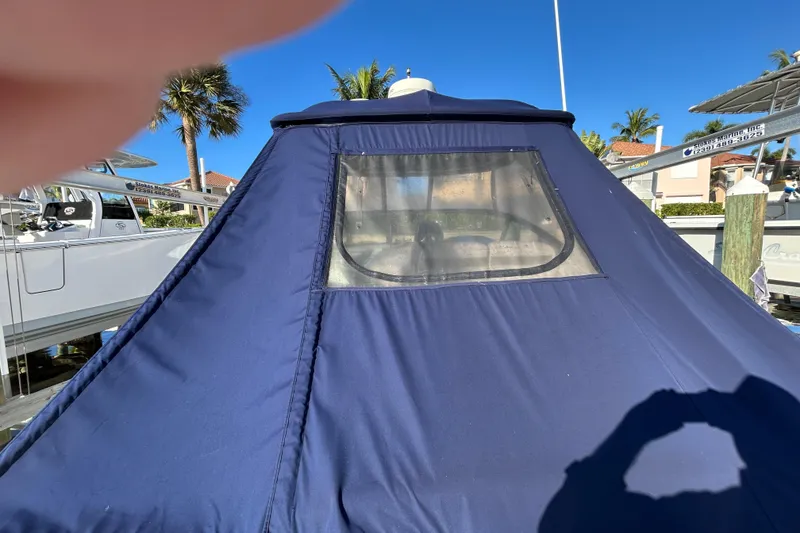 Slide: The Image of Blue canvas cover on 2006 Sea Ray 320 Sundancer boat, docked under clear sky. - 9