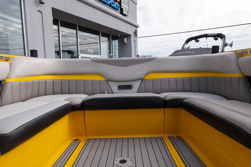 Slide: The Image of 2014 Malibu Wakesetter 24 MXZ interior with yellow and gray seating. - 16