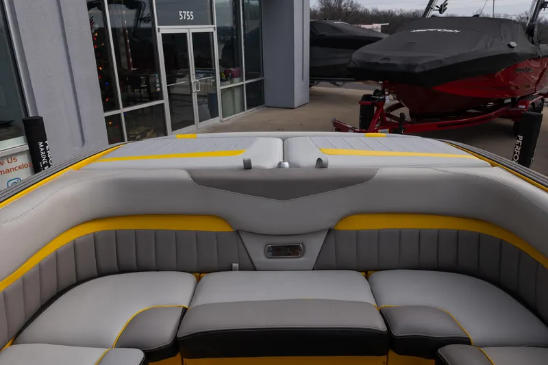 Slide: The Image of 2014 Malibu Wakesetter 24 MXZ boat interior with gray and yellow seating. - 17