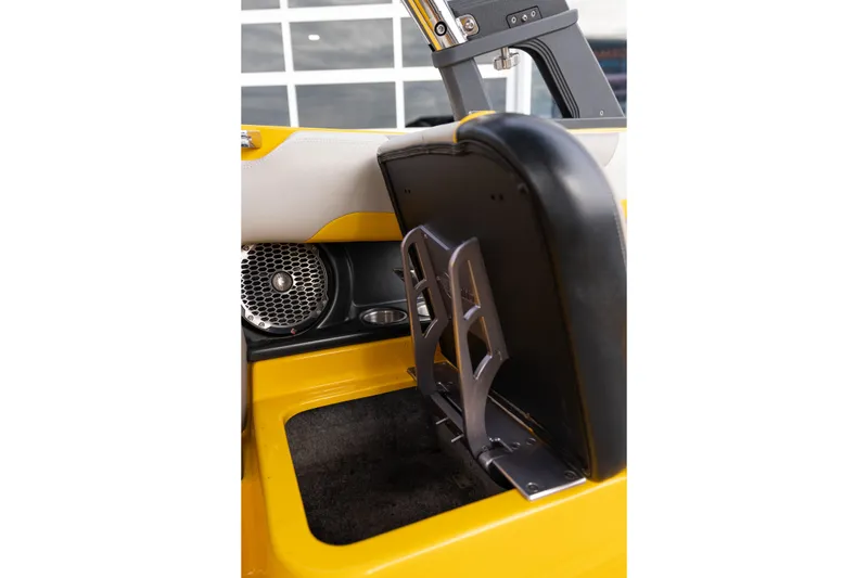 Slide: The Image of 2014 Malibu Wakesetter 24 MXZ interior with yellow accents and speaker detail. - 21