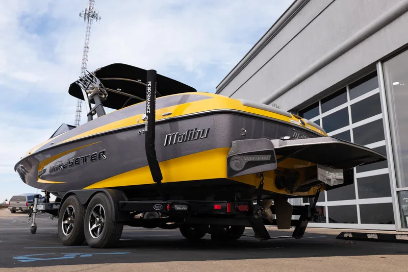 Slide: The Image of 2014 Malibu Wakesetter 24 MXZ boat on trailer, yellow and gray design. - 3