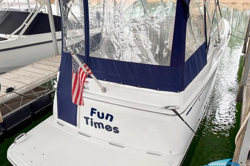 Slide: The Image of 2001 Chris-Craft 26 Constellation boat named "Fun Times" docked with American flag. - 1