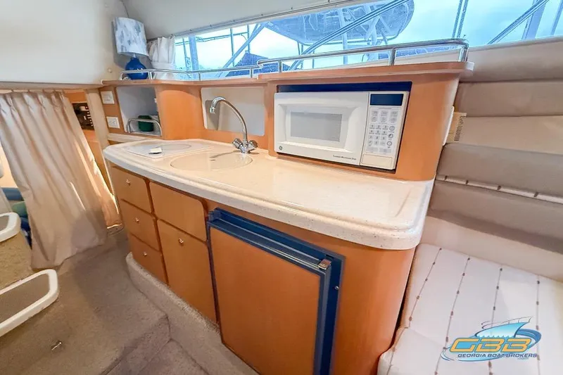 Slide: The Image of 2001 Chris-Craft 26 Constellation boat interior with kitchenette, sink, and microwave. - 15