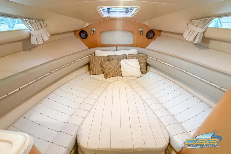 Slide: The Image of Luxurious cabin interior of 2001 Chris-Craft 26 Constellation with plush bedding and cushions. - 16
