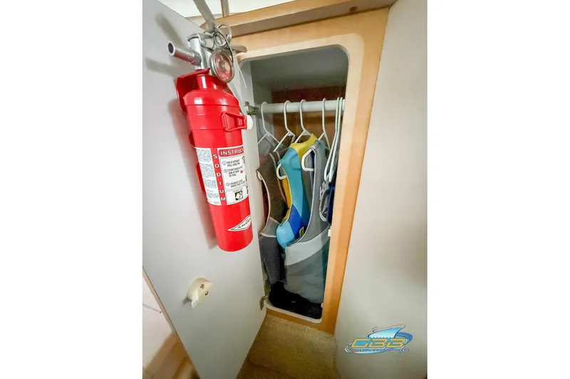 Slide: The Image of Cabinet with fire extinguisher and life jackets on Chris-Craft 26 Constellation, 2001 model. - 19