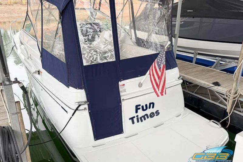 Slide: The Image of 2001 Chris-Craft 26 Constellation boat named "Fun Times" docked with American flag. - 2