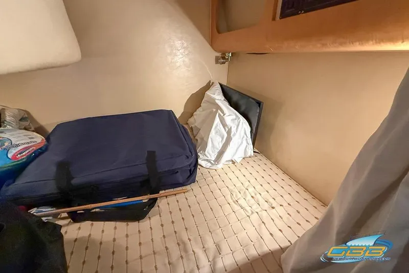 Slide: The Image of Interior cabin of 2001 Chris-Craft 26 Constellation with bedding and storage items. - 20