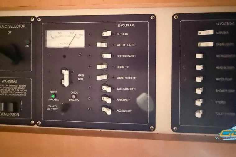 Slide: The Image of Electrical control panel on 2001 Chris-Craft 26 Constellation boat, featuring various switches and indicators. - 21