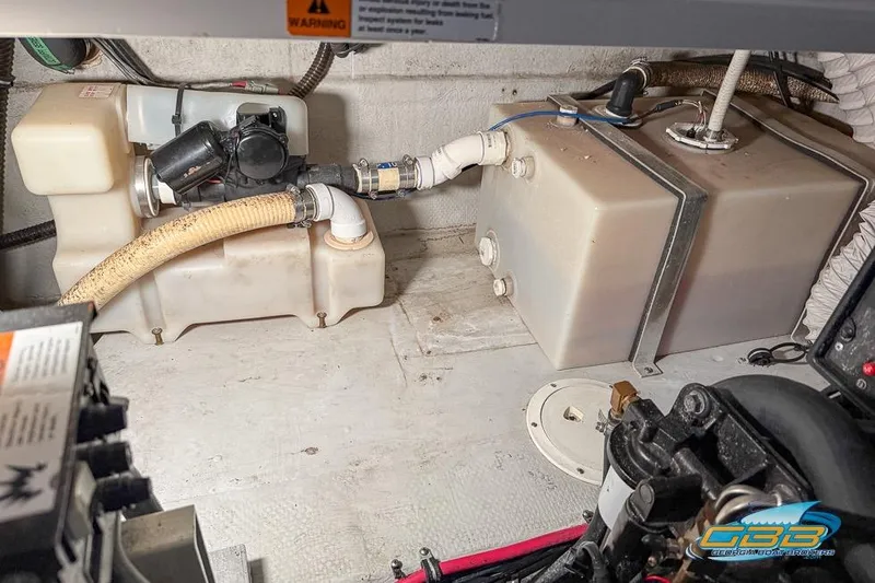 Slide: The Image of Engine compartment of 2001 Chris-Craft 26 Constellation with tanks and hoses visible. - 26