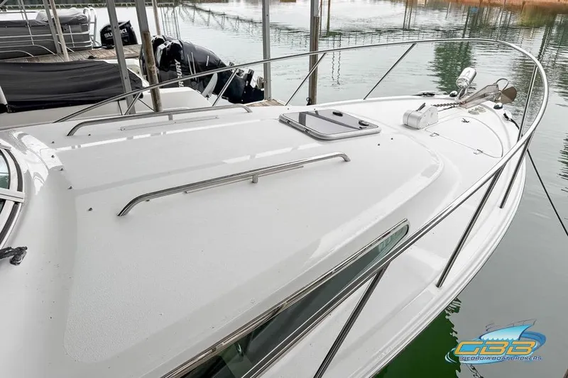 Slide: The Image of 2001 Chris-Craft 26 Constellation boat docked, showcasing sleek design and polished railings. - 5