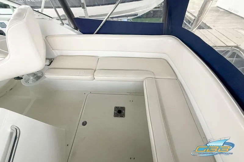 Slide: The Image of 2001 Chris-Craft 26 Constellation boat interior with white seating and blue canopy. - 6