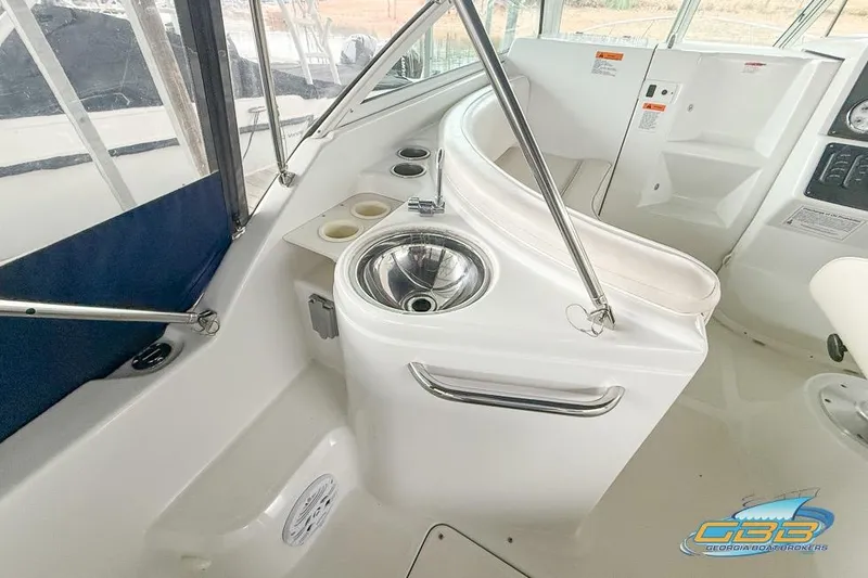 Slide: The Image of 2001 Chris-Craft 26 Constellation boat interior with sink and cup holders. - 7