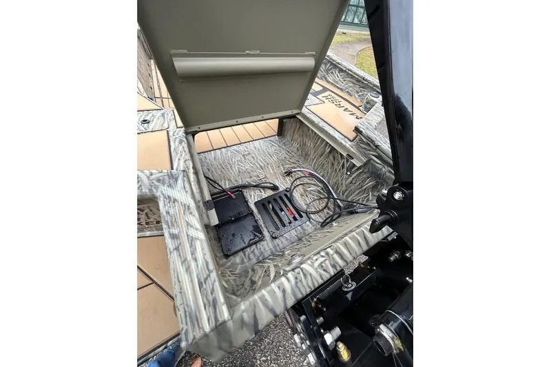 Slide: The Image of 2026 Tracker Grizzly 1756 T Marsh boat storage compartment with wiring and equipment. - 11