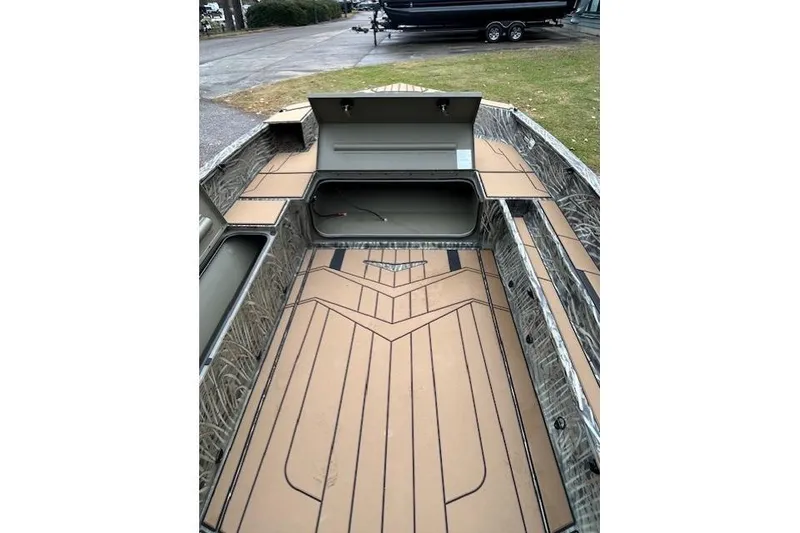 Slide: The Image of 2026 Tracker Grizzly 1756 T Marsh boat interior with open storage compartments. - 4
