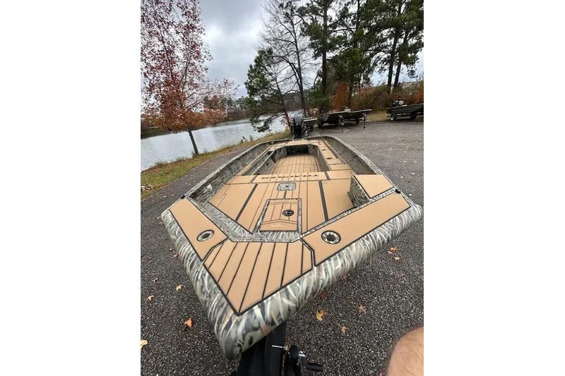 Slide: The Image of 2026 Tracker Grizzly 1756 T Marsh boat on a lakeside, surrounded by autumn trees. - 7