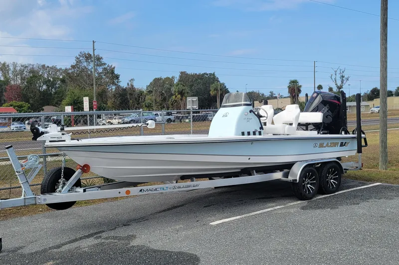 The Image of 2026 Blazer 675 Ultimate Bay boat on trailer in parking lot. - 1