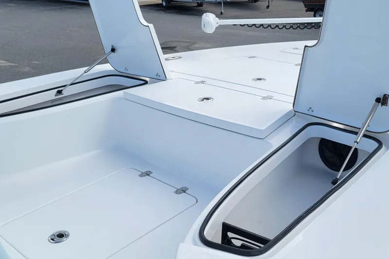 Slide: The Image of 2026 Blazer 675 Ultimate Bay boat with open storage compartments on deck. - 11