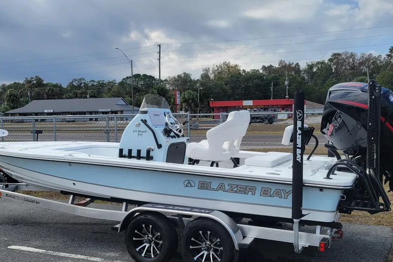 Slide: The Image of 2026 Blazer 675 Ultimate Bay boat on trailer, parked outdoors, showcasing sleek design. - 3