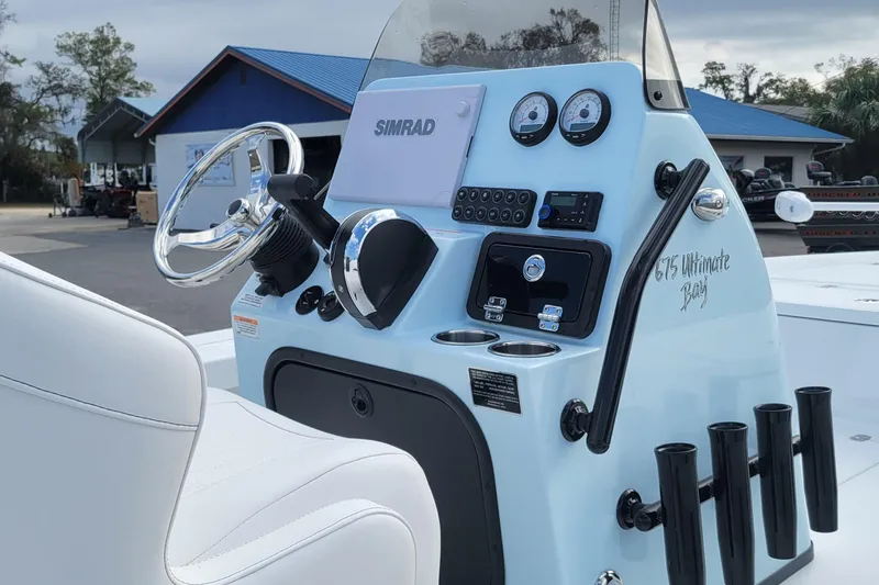 Slide: The Image of 2026 Blazer 675 Ultimate Bay boat dashboard with steering wheel and control panel. - 7