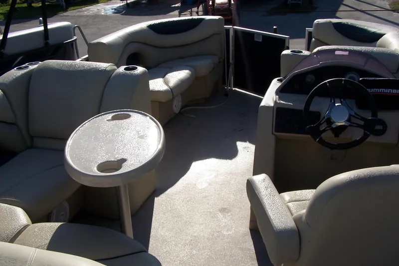 Slide: The Image of 2019 Sylvan 8520 Mirage F-n-C pontoon boat interior with seating and steering wheel. - 2