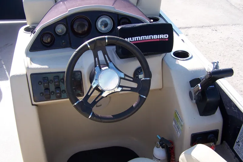 Slide: The Image of 2019 Sylvan 8520 Mirage F-n-C boat dashboard with steering wheel and controls. - 3