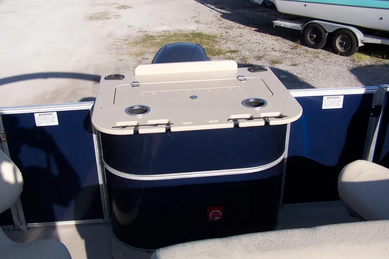 Slide: The Image of 2019 Sylvan 8520 Mirage F-n-C boat interior with storage compartment and cup holders. - 5