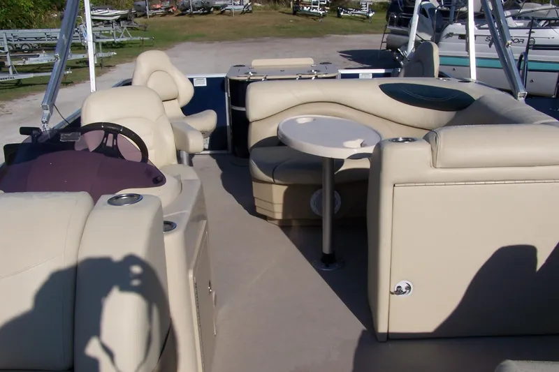 Slide: The Image of Interior of 2019 Sylvan 8520 Mirage F-n-C pontoon boat with beige seating and table. - 7