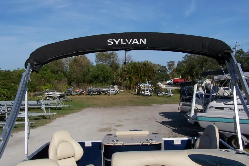 Slide: The Image of 2019 Sylvan 8520 Mirage F-n-C pontoon boat with canopy in a marina setting. - 9