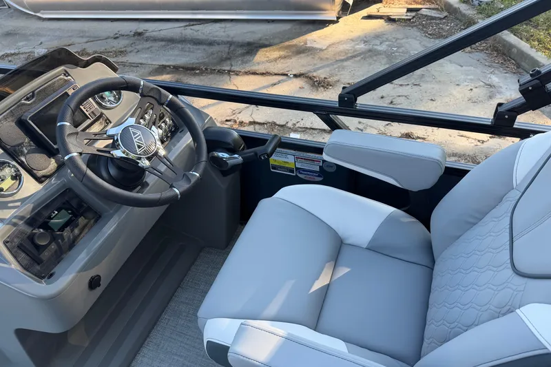Slide: The Image of 2026 Avalon VENTURE CC boat interior with steering wheel and comfortable seating. - 2