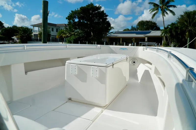 Slide: The Image of Invincible boat deck with storage, surrounded by tropical scenery and clear blue sky. - 14