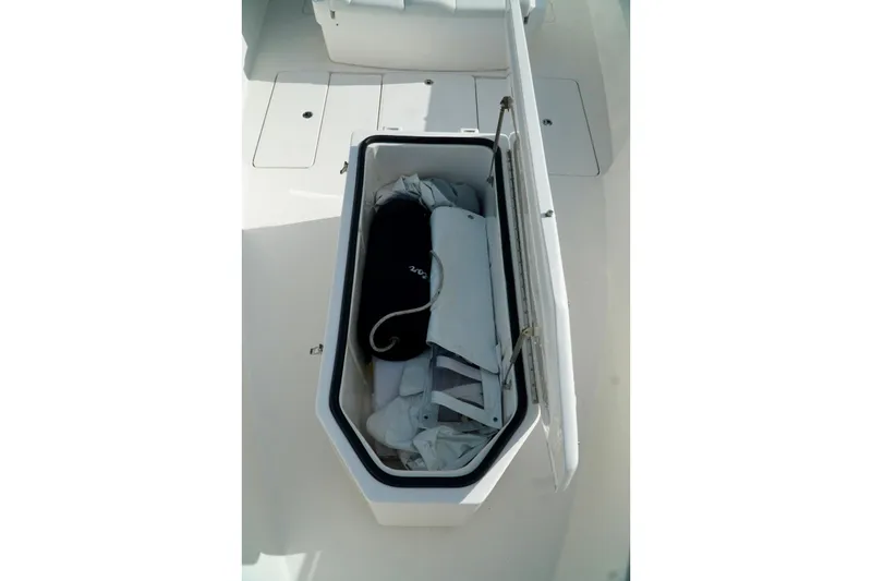 Slide: The Image of Open storage compartment on Invincible boat with equipment inside. - 15