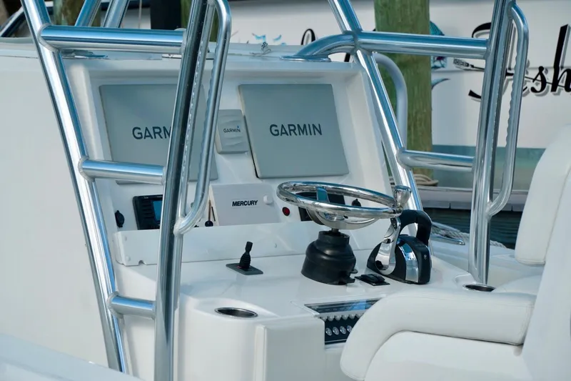 Slide: The Image of Invincible boat console with dual Garmin displays and Mercury controls. - 21