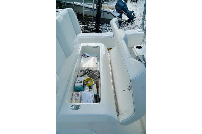 Slide: The Image of Open storage compartment on Invincible boat with various tools and supplies. - 29