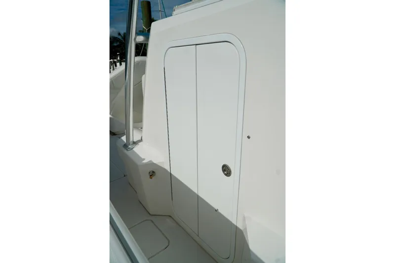 Slide: The Image of White Invincible boat compartment door with sleek design and chrome handle. - 37