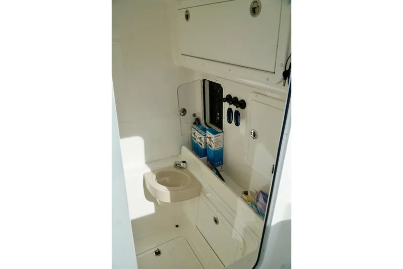 Slide: The Image of Compact boat interior with sink, storage compartments, and control panel, Invincible make. - 40