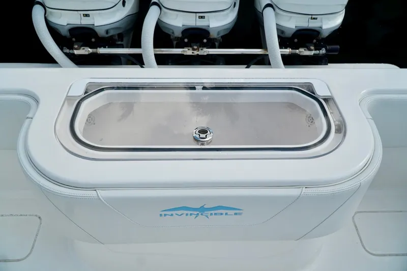 Slide: The Image of Invincible boat with sleek livewell and powerful engines, showcasing modern marine design. - 51