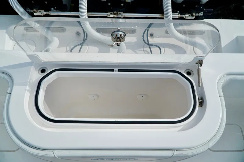 Slide: The Image of Open livewell on Invincible boat with clear lid and white interior. - 52