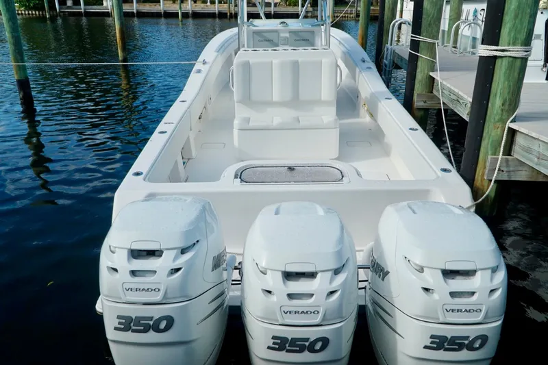 Slide: The Image of Invincible boat with triple Mercury Verado 350 engines docked in marina. - 53