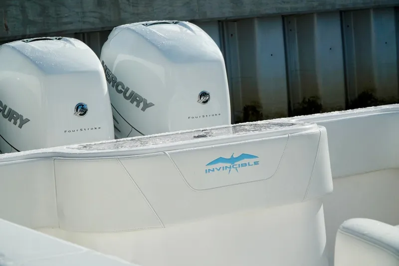 Slide: The Image of White Invincible boat with dual Mercury FourStroke engines at dock. - 55