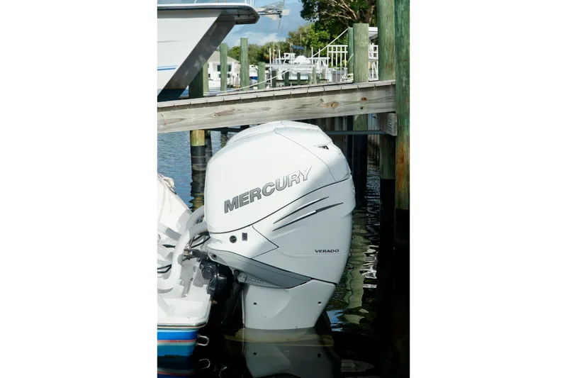 Slide: The Image of Mercury Verado outboard motor on Invincible boat docked by wooden pier. - 59