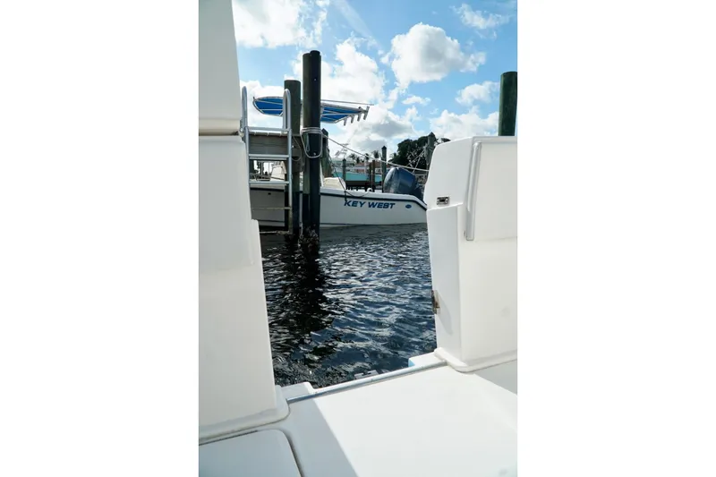 Slide: The Image of Invincible boat docked near Key West, clear sky, and calm water. - 67