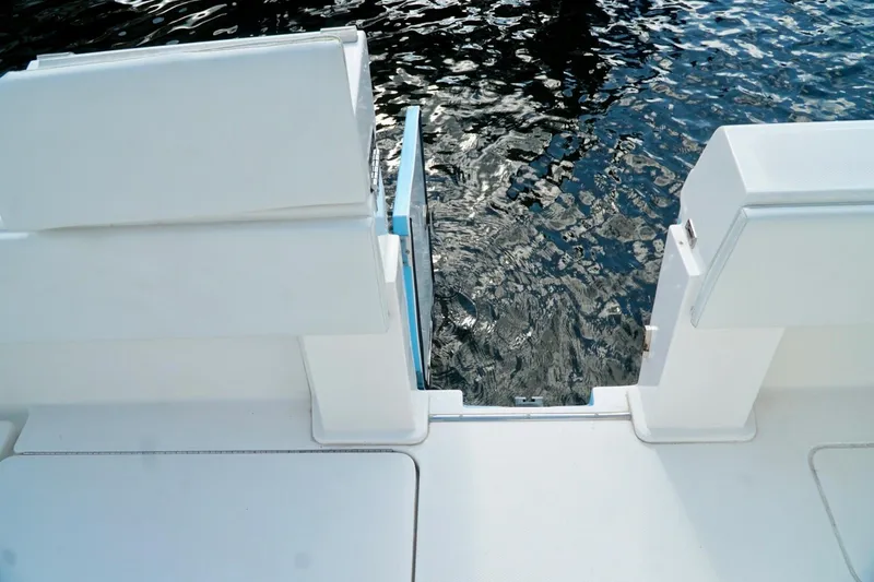 Slide: The Image of White Invincible boat deck with water view through open transom door. - 68