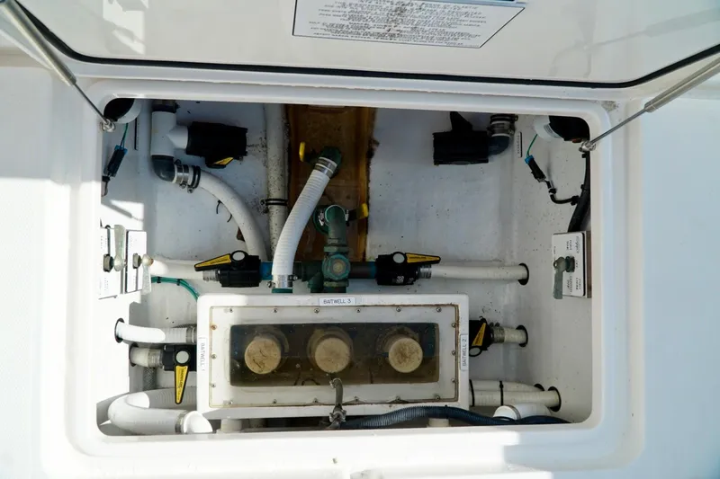 Slide: The Image of Boat plumbing system with pipes and valves inside an Invincible model compartment. - 69